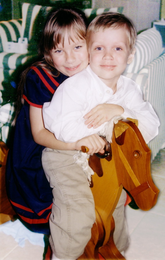 Emily and Luke on the rocking horse their grandfather made